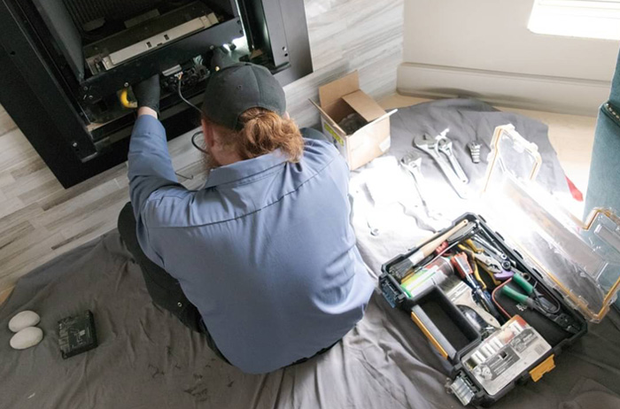 Original Photo- Technician Working On Fireplace- Mountain Man Fireplace & Chimney Technician working on fireplace