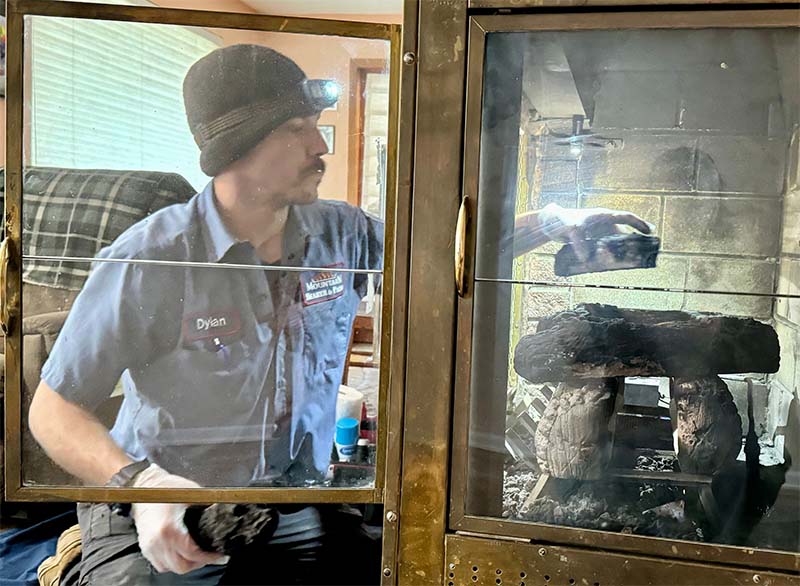 Mountain Man - M Original image of gas appliance repair Technician working on fireplace