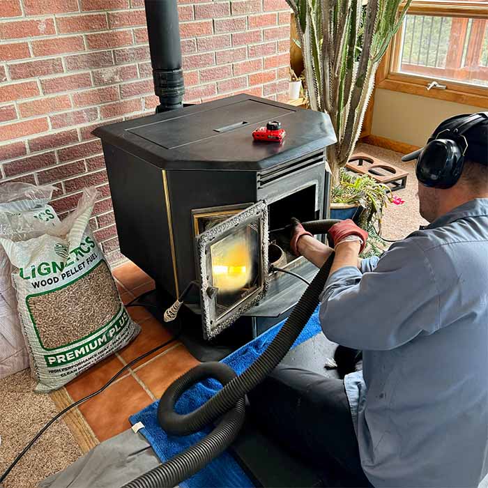 Technician sweeping stove
